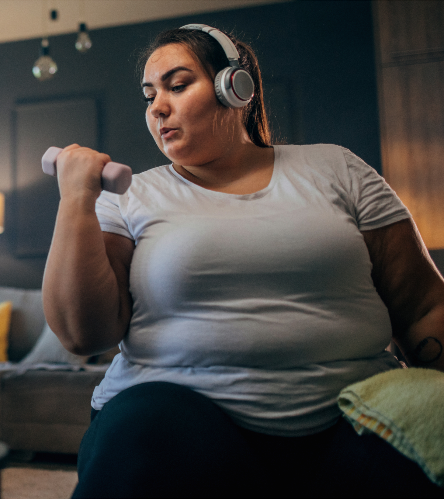 A woman in her early thirties and listening to music as she fits in physical activity to her daily routine as part of her virtual care program for managing obesity.