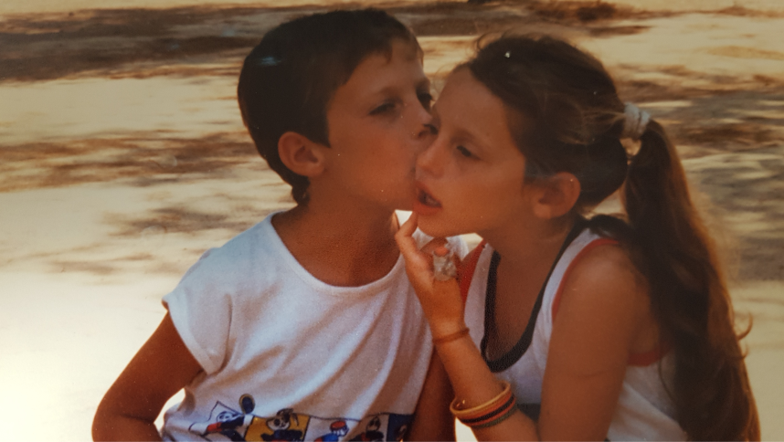 Two children, Eyal and Tamar, sit on a bench.