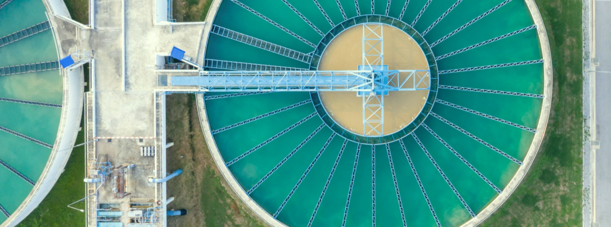 Aerial view of a wastewater treatment facility showing large tanks and filtration systems Aerial view of a wastewater treatment facility showing large tanks and filtration systems