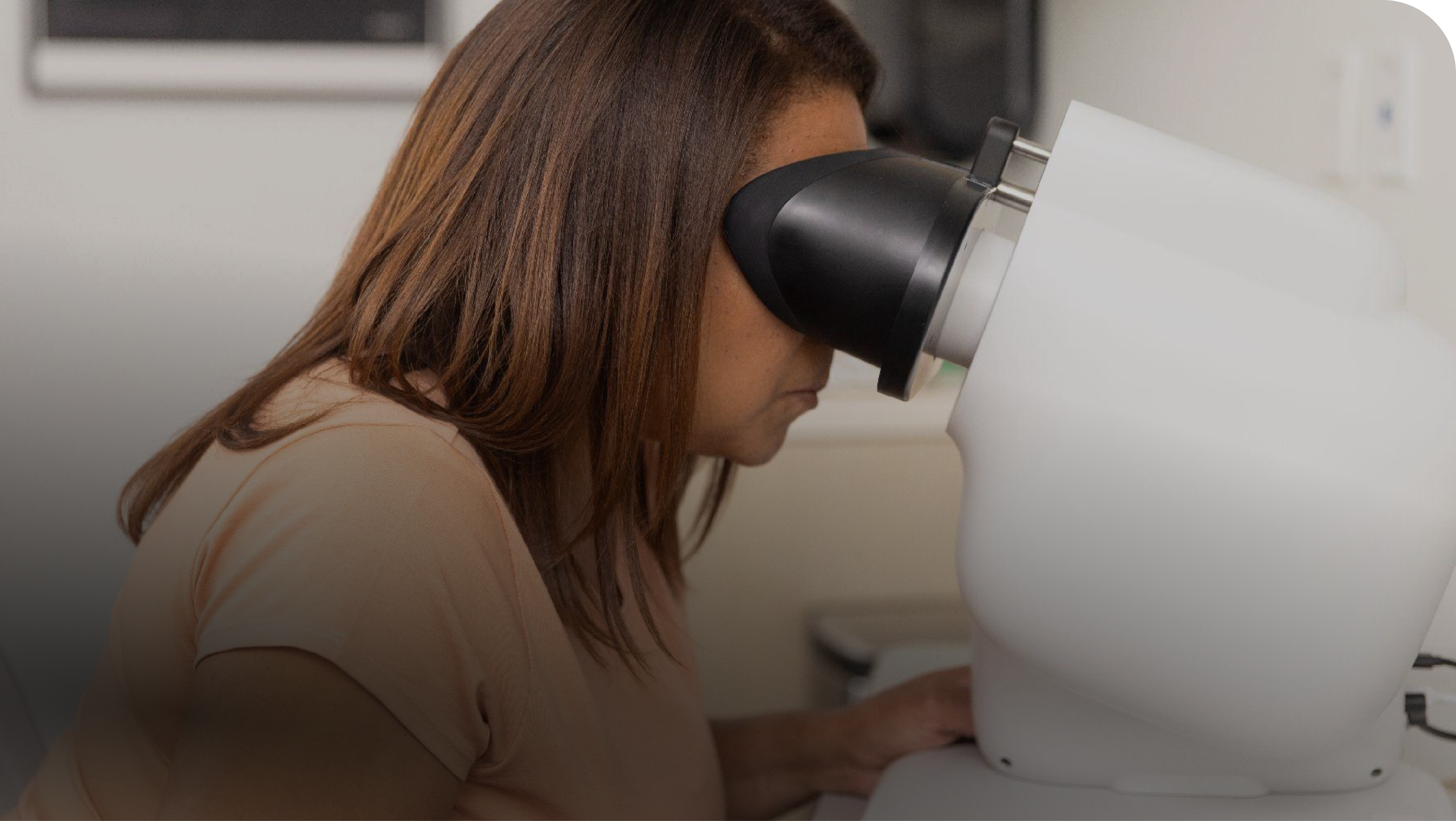 Patient placing their head onto the Verily Retinal Camera for screening